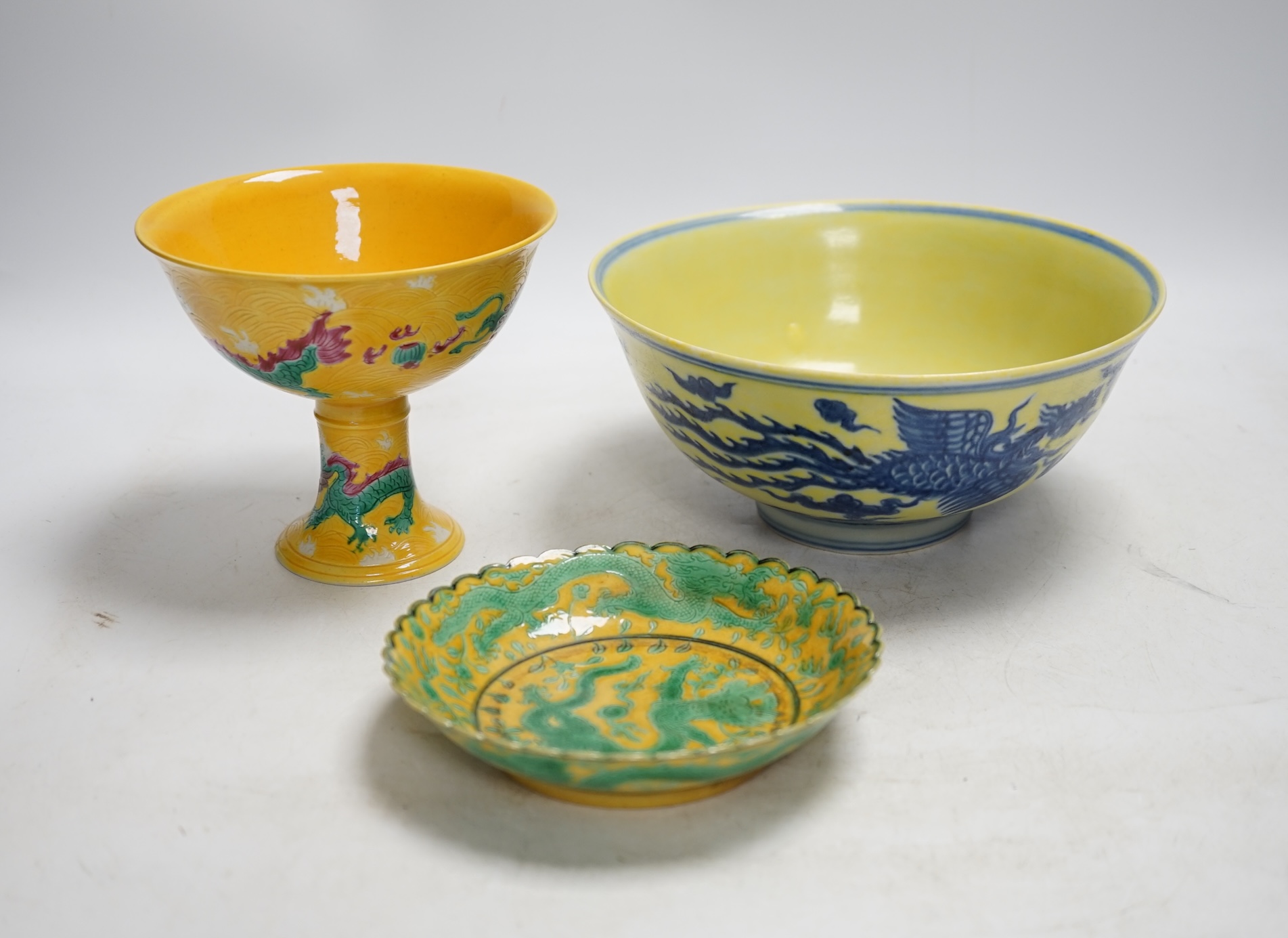 A Chinese yellow ground underglaze blue 'dragon' bowl, boxed, a yellow and green 'dragon' dish and a similar stem cup, yellow bowl 19.5cm diameter. Condition - good